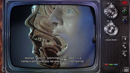 Screenshot of an old television, playing a documentary about human speech synthesis. A split human head is seen, organs and all. Caption reads: Human speech, seemingly so simple, is a complicated process no one fully understands.